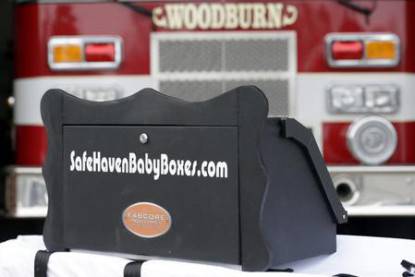 A prototype of a baby box, where parents could surrender their newborns anonymously, is shown outside the fire station in Woodburn, Ind., Thursday, Feb. 26, 2015. The box is actually a newborn incubator, or baby box, and it could be showing up soon at Indiana hospitals, fire stations, churches and other selected sites under legislation that would give mothers in crisis a way to surrender their children safely and anonymously. (AP Photo/Michael Conroy)