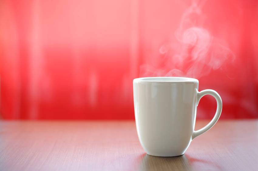 hot coffee or tea in the mug with real smoke ready to drink