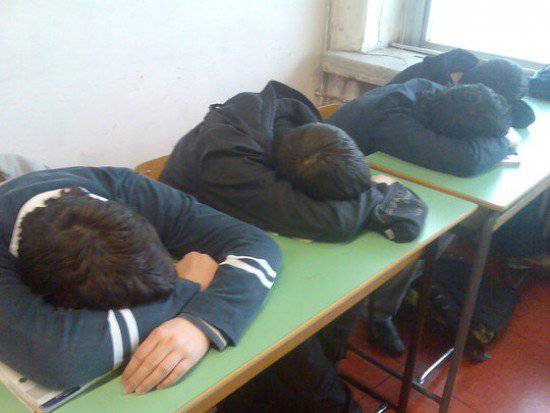 bambini dormono sui banchi di scuola