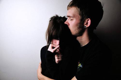 Un uomo bacia la propria donna