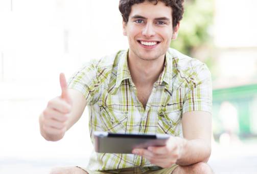 Man with digital tablet showing thumbs up