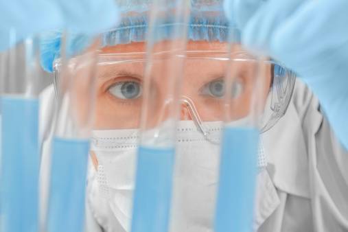 Man scientist looks at a few test tubes