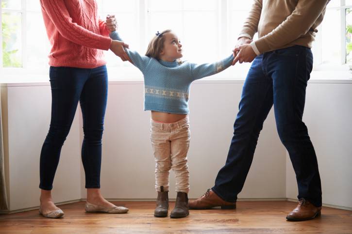 Two Parents Fighting Over Child In Divorce Concept
