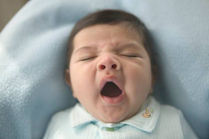 High angle view of a baby yawning